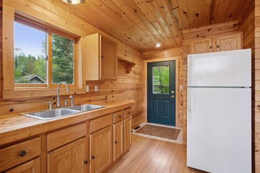 Kitchen and front entry. Closet to right of door for coats.