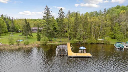 Great dock with chairs and sun shade and stairs to the water.