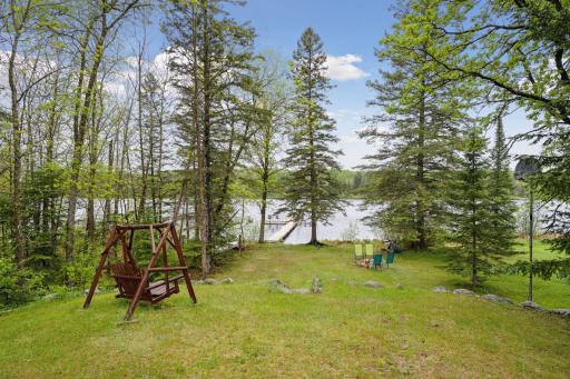 Lake front with swing and fire pit. Both included.