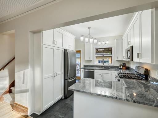 Featuring quartzite countertops - prized for their natural beauty and durability - paired with custom cabinetry for a functional kitchen.