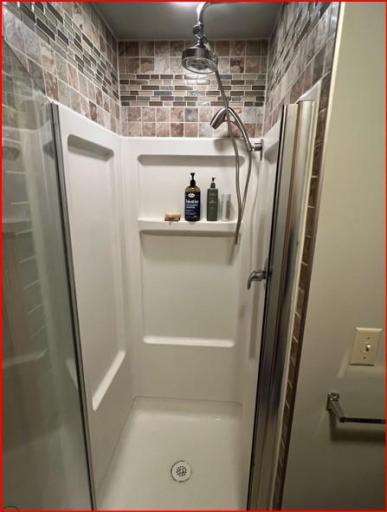 Lower-level shower with tile.