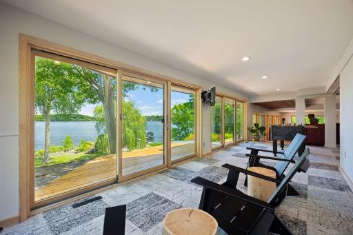 The corner-to-corner window panorama is the most unique aspect of this home---unlike any other. Behind the wall against which these chairs sit is a large space that could support an additional large bedroom.