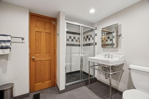 The lower-level bath is large with an interior closet, tucked near the bedroom, and a sauna.