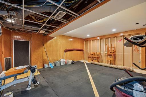 Currently used as storage space, this area offers flexibility for another bedroom, an exercise space, or hobby area. The partitioning wall could easily be modified to enable this interior space, to have a lake vista.
