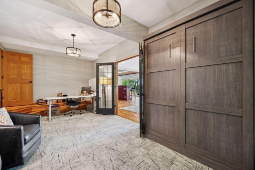 The fourth bedroom resides in the lower level and is currently used as an office. in this case, a Murphy bed folds against the wall.