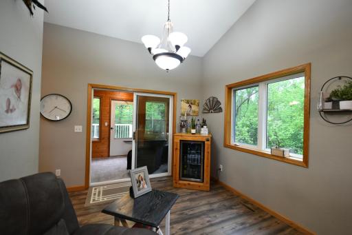 living room leads to the screened in porch or kitchen