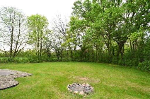 large backyard with mature trees & firepit