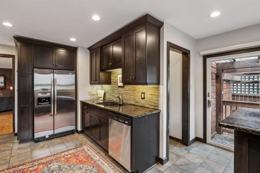 This room lead out to an outside oasis! Paver patio and pergola await!