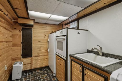 Additional oven and stand-up freezer in the laundry room area.
