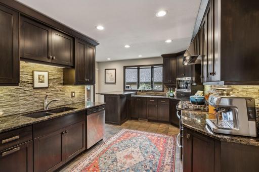 This room also features tile flooring, granit counter tops and high-end appliances.