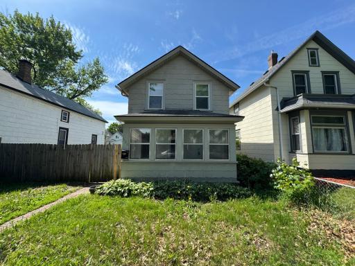Beautiful front yard with a nice wooden fence to create privacy between the front and back of house.