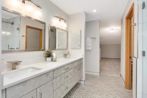 The custom double vanity has modern fixtures and soft-close cabinets