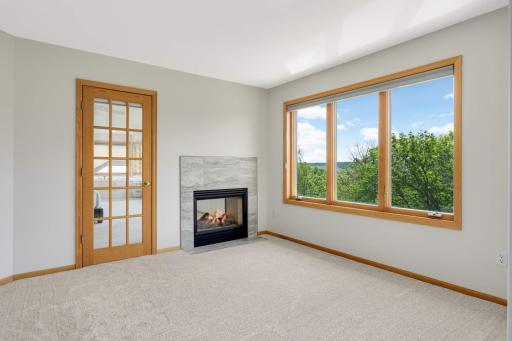 The fourth bedroom on the upper level adjoins to the primary bedroom and is presently used as a sitting room