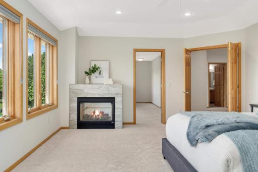 The gas fireplace in the primary bedroom is the perfect place to relax on a chilly day