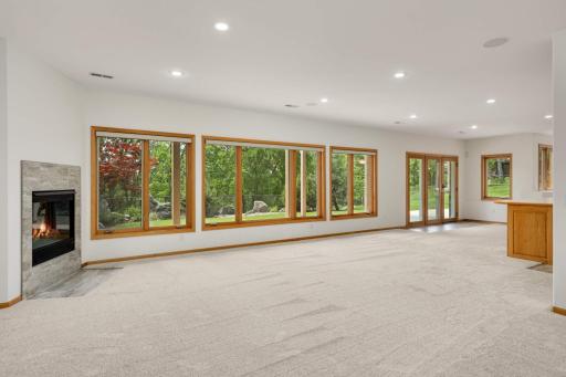 The walkout level overlooks a new patio and lush landscaping