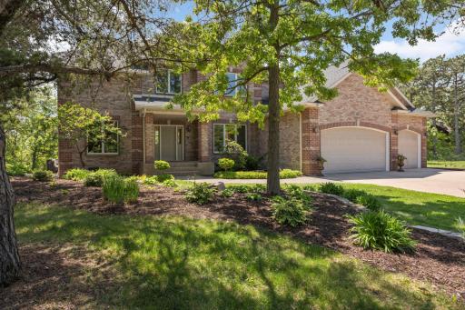 Lush landscaping and mature trees bring privacy and serenity