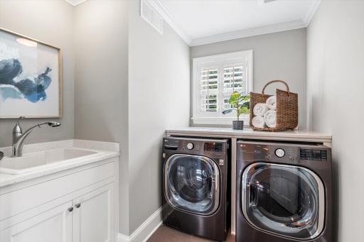 Laundry room with a wash tub conveniently located on the second floor. Washer and Dryer new in 2023.