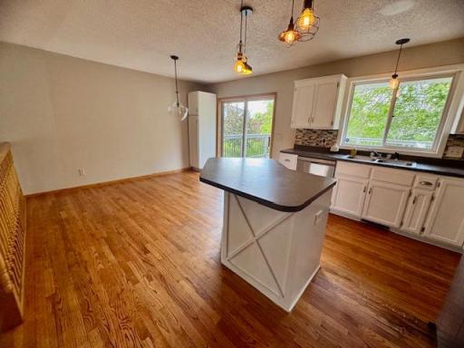 Spacious kitchen dining area with slider door that walks out to the deck