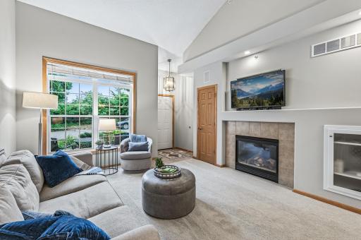Welcome home! This cozy yet expansive living area features a gas fireplace and beautiful natural light from oversized windows.