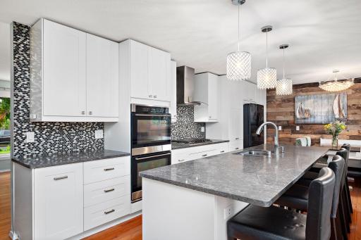 Double oven, custom backsplash, vented hood