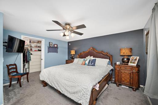Lower level bedroom as owners getaway or teen/college student haven, with walk in closet, ceiling fan.