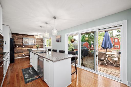 Large Quartz island, the center of the home! Notice new three panel slider with tinted windows!