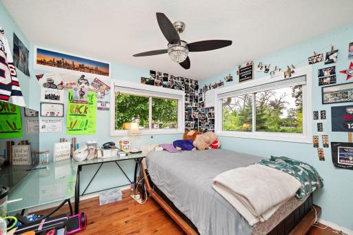 One of three bedrooms on main level with ceiling fan