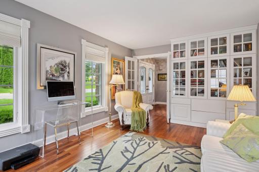 Built-ins bookcases and file cabinets make the sunroom double as a wonderful office.