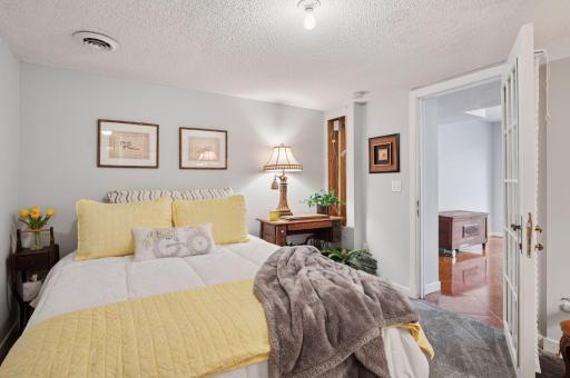 The guest room, while no direct egress window is steps away from the walk-out doors. Used as a 5th bedroom for decades!