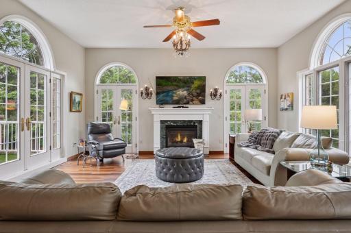 In 1999, an expansive addition was created. Here is the main floor living room surrounded by windows, high ceilings, gas fireplace, and may turn into your favorite room in the home!