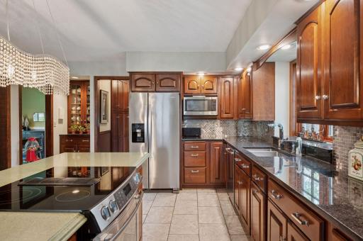 Granite counters, stainless steel appliances, tile backsplash, custom cabinets, and tile floor make an amazing kitchen for cooking and entertaining.