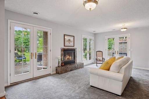 Cozy up to the fireplace and overlook the tranquil backyard spaces.