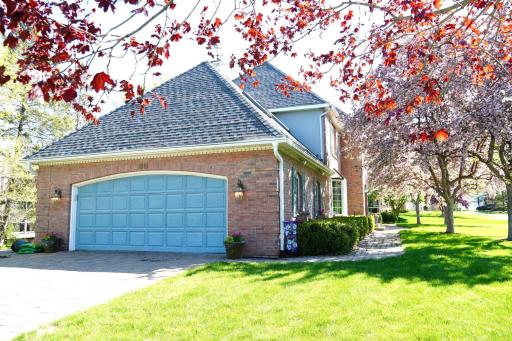 Attached 2 car garage, complete with custom paver driveway and sidewalk.