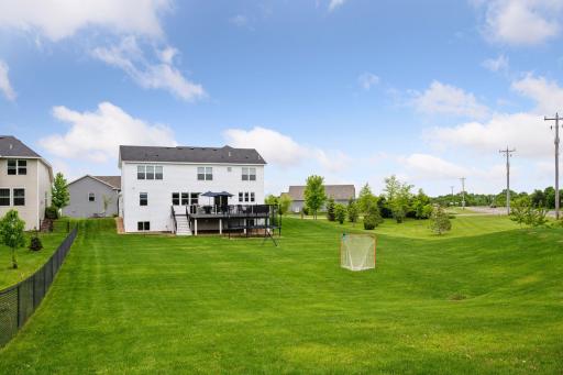 Huge corner lot features a flat, easy mow lawn with plenty of room for outdoor games or even a garden.