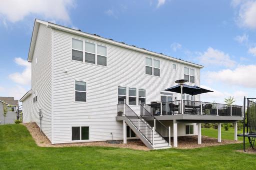 Stairs down to the backyard from the oversized deck makes yard access convenient.