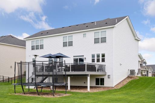 Another view highlighting the expansive home, oversized deck and plenty of room for play and relaxation.