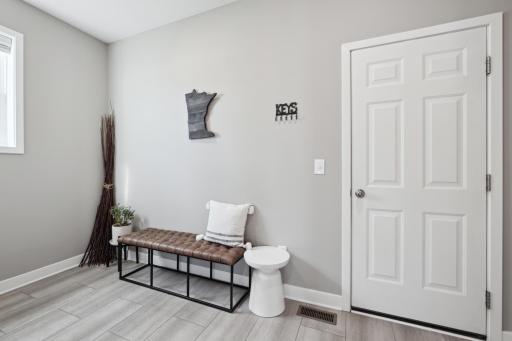 Large and light mud room includes a walk-in closet with easy access to the oversized garage, perfect for MN seasonal outerwear.