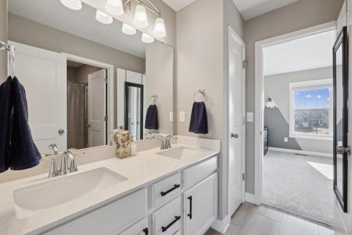A private Jack and Jill bathroom with dual sinks is conveniently nestled between the 2 bedrooms.