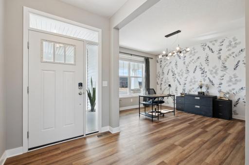 A beautiful front door with keyless entry opens to a bright and open formal dining room just off the generous foyer.