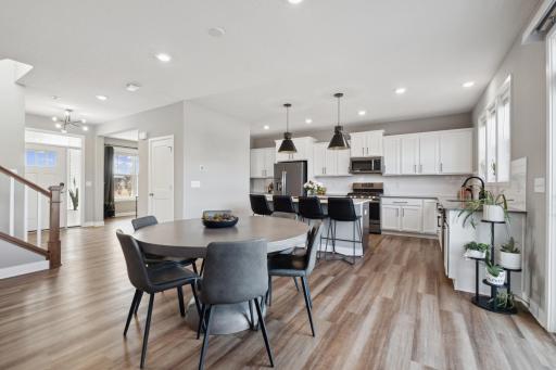 The open-concept layout seamlessly connects the dining area, kitchen, and living roomâperfect for hosting memorable holiday gatherings with family and friends.