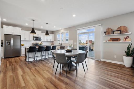 The charming dining area walks out to a maintenance-free deck overlooking the backyard, with easy access for summertime grilling.