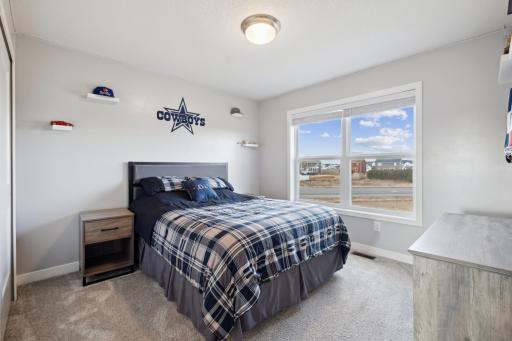Another spacious bedroom overlooks the backyard and features plush carpeting for added comfort and warmth.