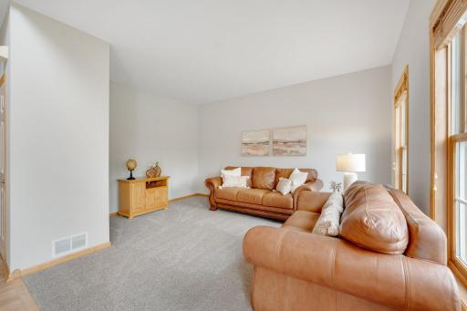 The spacious Living Room greets your arrival through the front door