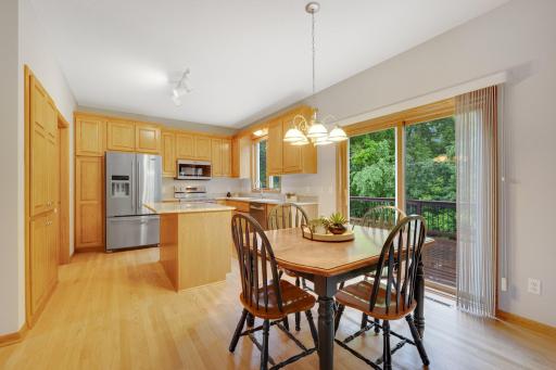 Refinished hardwood floors and an amazing view to the deck and backyard from the Informal Dining Area