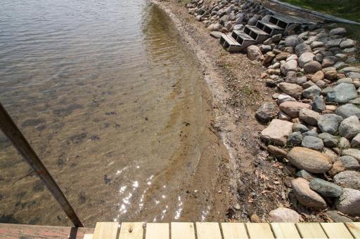 The lake bottom near shore is sandy and firm, and better with use. The bottom does soften as one goes deeper.
