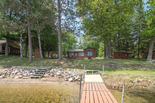 How's that for a beautiful setting! Nice beach. Mature trees. Classic cabin. Easy elevation!
