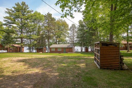 Looking across Sunflower Trail towards the cabin. Woodshed with wood to right is included.