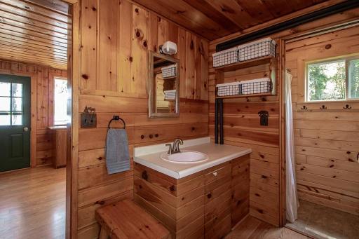 3/4 bath off roadside door to cabin. Notice shower curtain to right.