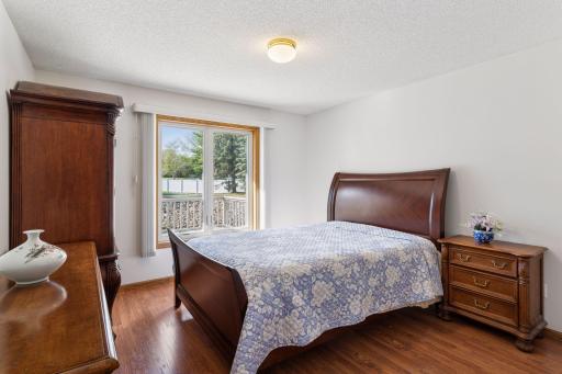 Primary bedroom with walk in closet and views of pond.