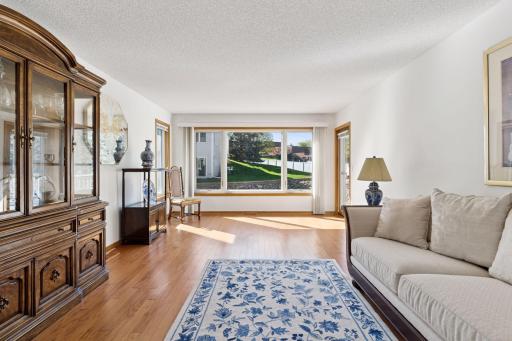 Large living room with beautiful views of the pond and access to back deck.